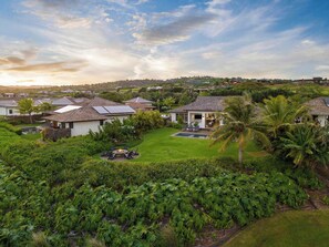 A residential area with houses, a swimming pool, and lush greenery. - Island Villa + Guest House | Pool, Hot Tub, Fire Pit, Hammock & Ocean Views (Koloa)