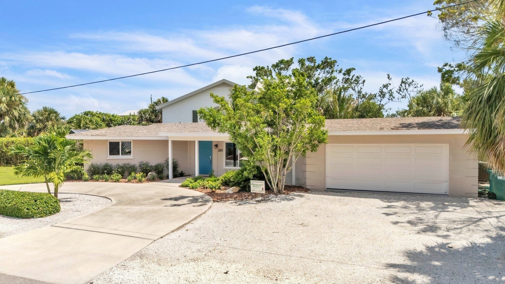 A single-story house with a garage, a front porch, and a well-maintained lawn.