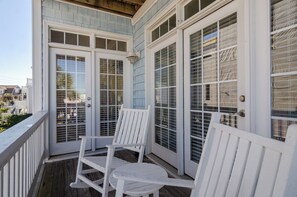 A covered porch with white railings and two white rocking chairs. - 4BR Duplex Steps to Beach! (Kure Beach)