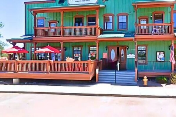 A two-story building with balconies and a front porch.