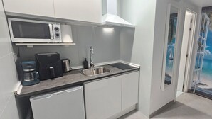 A compact kitchen with a microwave, coffee maker, and sink. - Apartment - Ground floor VTV A2 (València)