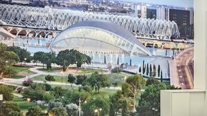 A bedroom with a large bed, a view of a stadium, and a cityscape. - Apartment - Ground floor VTV A2 (València)