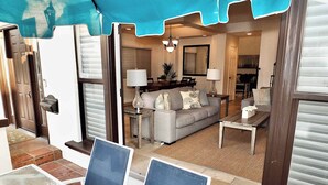 A living room with a sofa, coffee table, and chairs. There is a dining area with a table and chairs. - Beauty by the Beach Socal Fun! (Long Beach)