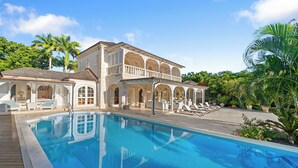 A large house with a swimming pool, outdoor seating, and a covered patio area. - Waterfalls - 6 bed Peaceful and Secure Luxury (Westmoreland)