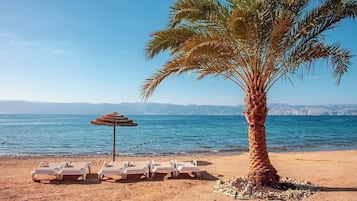 On the beach, sun loungers