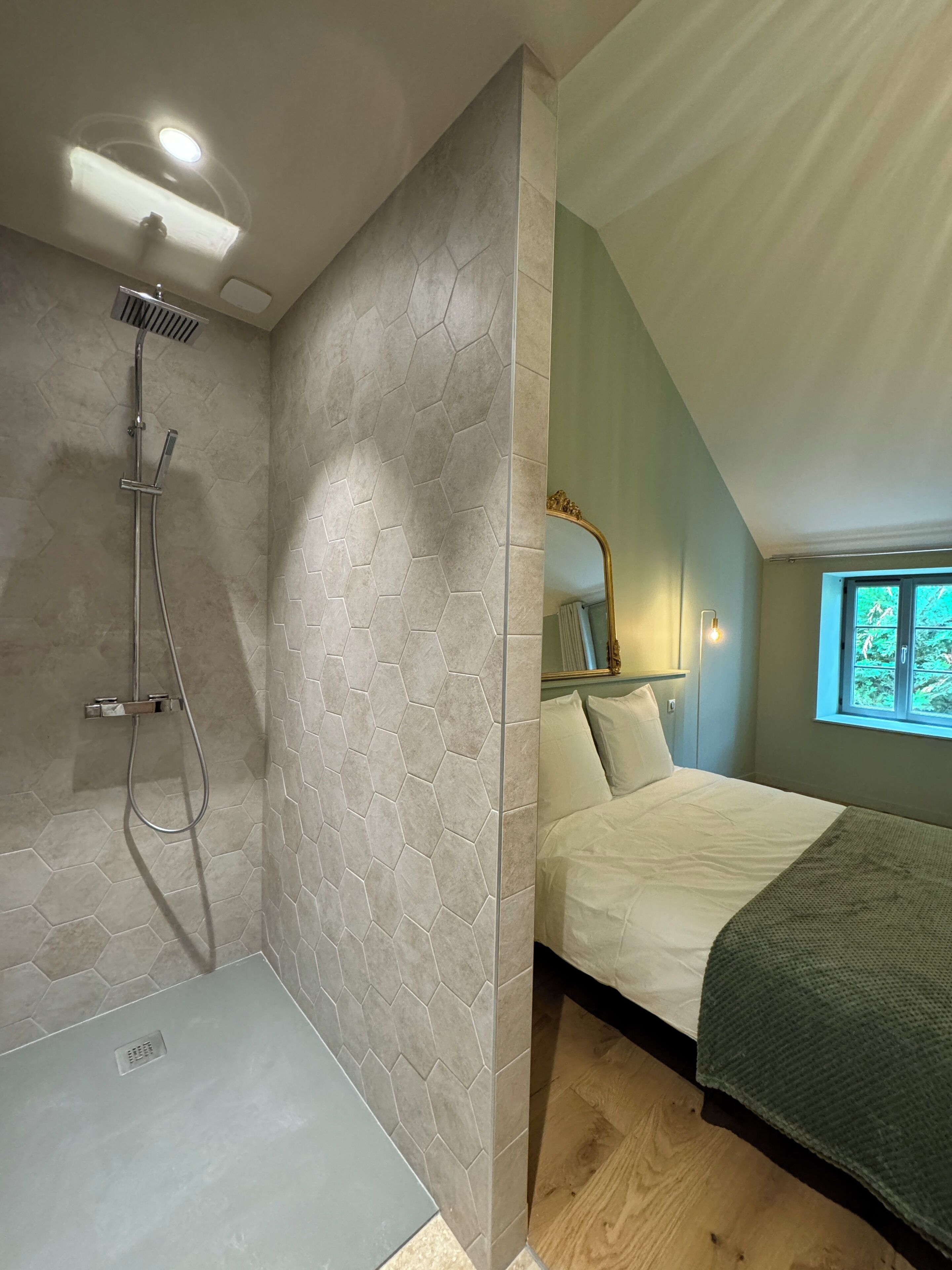 A modern bathroom with a shower, a toilet, and a sink.