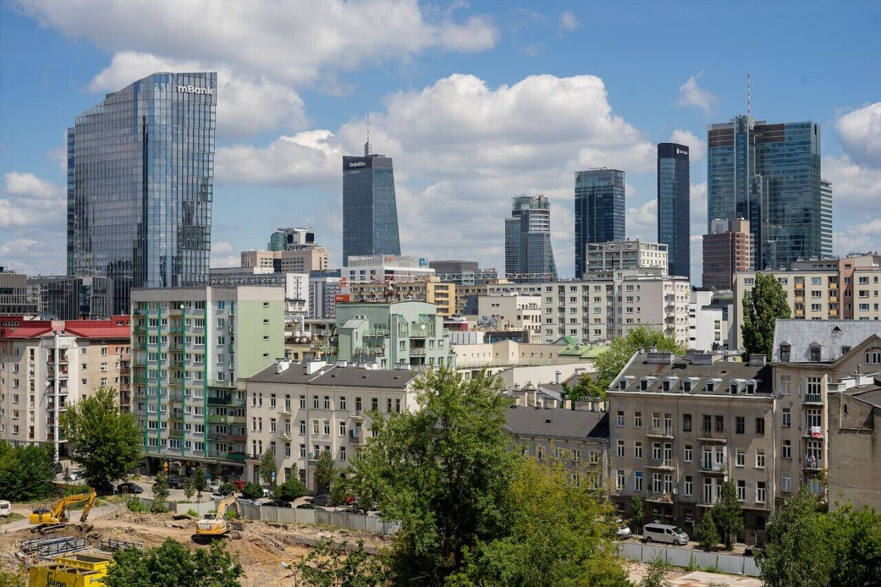 A cityscape with modern high-rise buildings and a mix of residential and commercial structures.