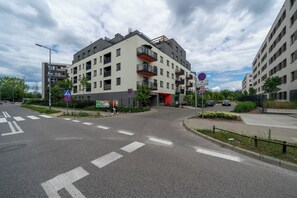 Situated at a street corner, this building offers a modern urban retreat with a flat roof and balconies.