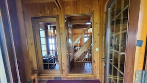 A wooden interior with a staircase leading to an upper level.