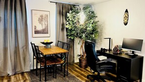 A room with a dining table, chairs, a desk with a computer, a plant, and a framed picture on the wall. - Family home in Dallas’s most prestigious neighborhood - Preston Hollow! 3 BR/2BA (Dallas)