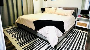 A bedroom with a bed, a nightstand, a lamp, a window, and a curtain. - Family home in Dallas’s most prestigious neighborhood - Preston Hollow! 3 BR/2BA (Dallas)