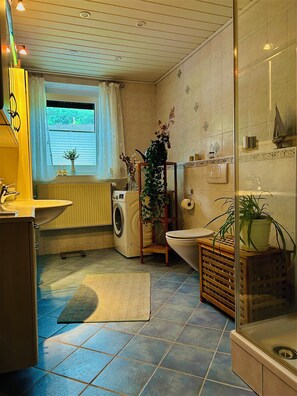 Shower, hair dryer, towels, toilet paper