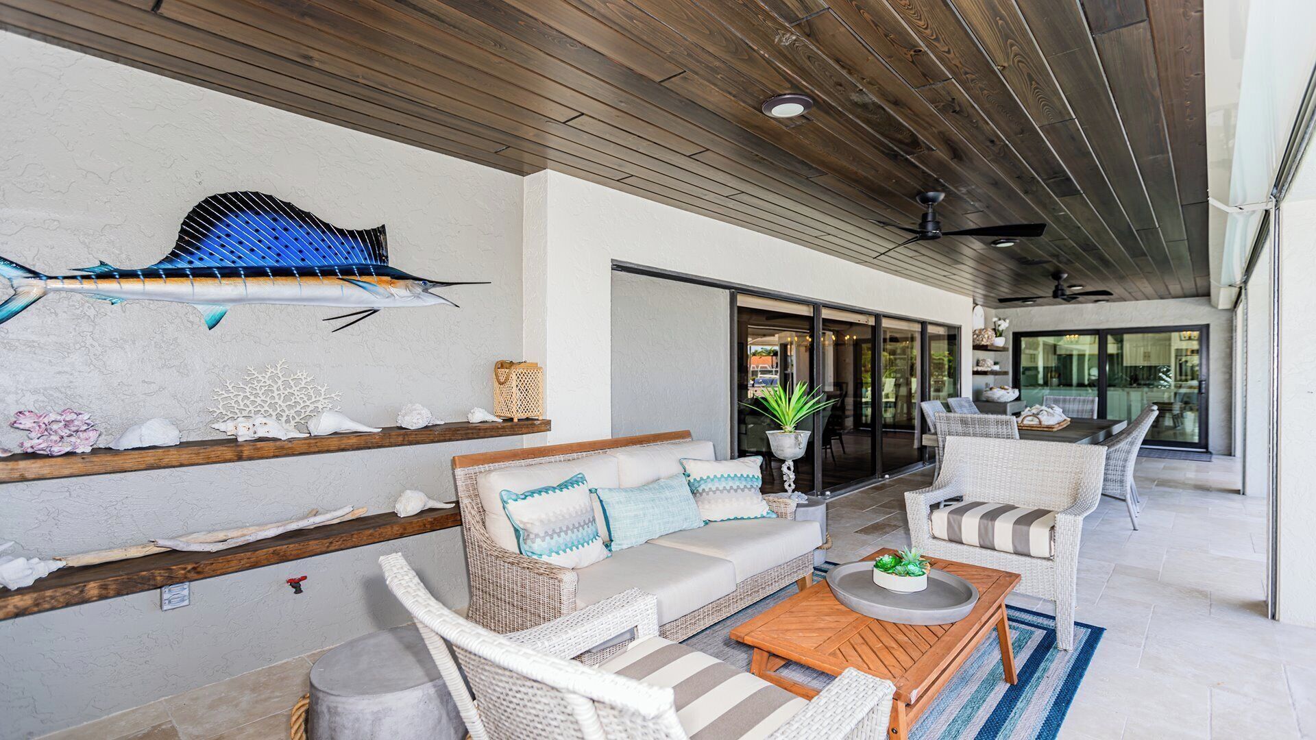 A spacious patio with a sofa, chairs, and a dining table.