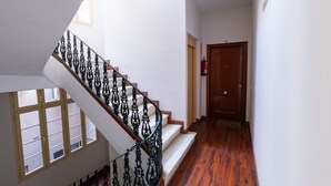 A staircase with ornate black railings leading to a landing. - Cubo's Estudio Malaga Center / city center / air conditioning / free wifi (Málaga)