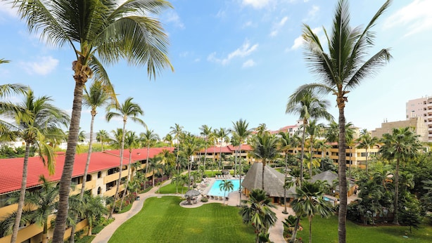 A resort with multiple buildings, a central pool area, and surrounding palm trees. - A-409 Enjoy Your Vacation In This Exquisite Condominium! (Cabo San Lucas)