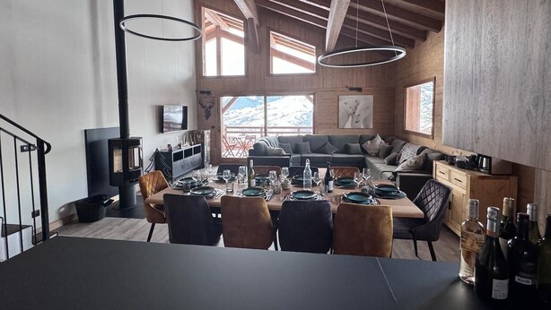A modern kitchen with a dining area, wooden beams, large windows, and a fireplace. - JARDIN ALPIN 1 - LA PLAGNE TARENTAISE (LA PLAGNE TARENTAISE)