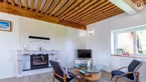 A living room with a fireplace, a television, and two chairs around a glass table. - ESCALE - LA MOTTE SERVOLEX (LA MOTTE SERVOLEX)