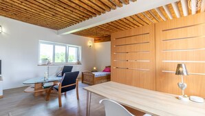 A modern room with a wooden ceiling, a desk with a chair, a bed, and a window with a view of greenery. - ESCALE - LA MOTTE SERVOLEX (LA MOTTE SERVOLEX)