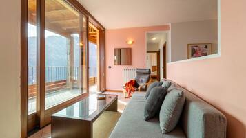 Apartment, Lake View | Living area | 35-inch TV with digital channels