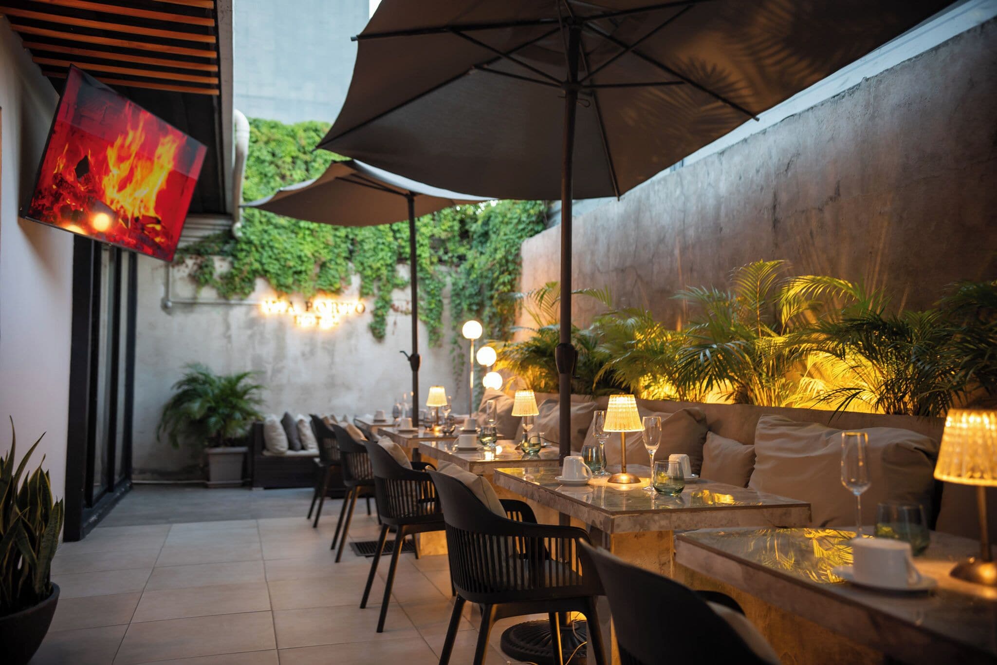 An outdoor dining area with tables, chairs, and umbrellas.