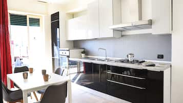 Apartment, Balcony | Private kitchen | Fridge, oven, stovetop, coffee/tea maker