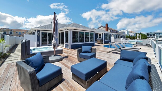 A rooftop deck with outdoor seating, a hot tub, and a swimming pool. - Waterfront Mantoloking Home with Private Dock w/Pool very close to Ocean Beach  (Mantoloking)
