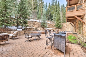 An outdoor patio with stone flooring, a barbecue grill, and outdoor furniture. - 1 Bedroom Condo (Keystone)