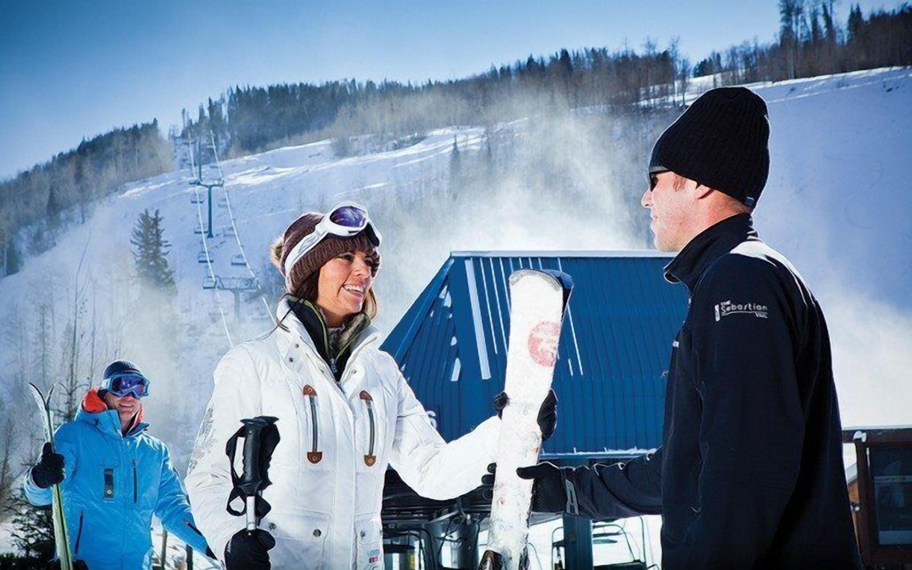 A ski resort with a chairlift, snow-covered slopes, and skiers.
