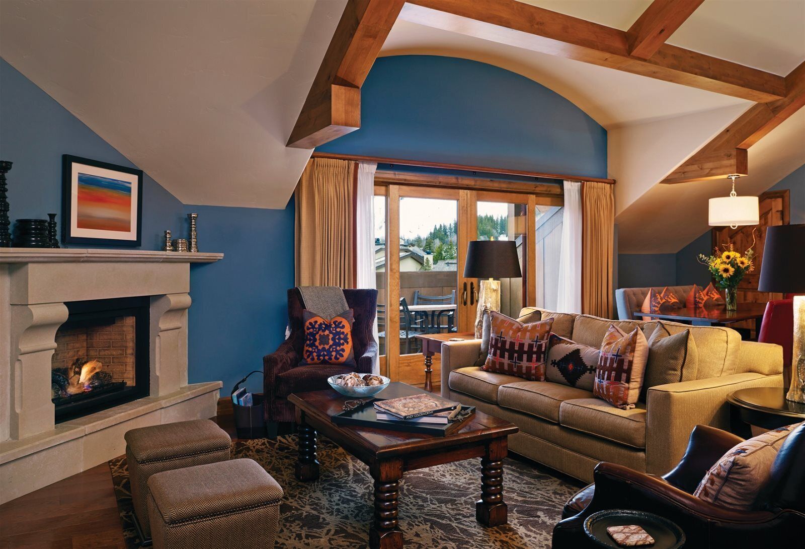 A cozy living room with a fireplace, a sofa, a chair, and a coffee table.