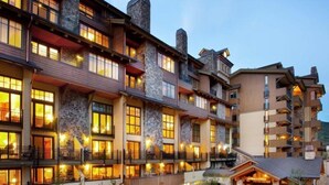 A multi-story hotel with stone facades, balconies, and a landscaped courtyard. - 3 Bedroom Condo (Vail)