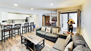 A modern apartment with a kitchen, dining area, and living room. - 3 Bedroom Condo (Keystone)