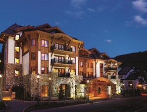 A multi-story hotel with stone facade, balconies, and a stone archway entrance. - 3 Bedroom Residence (Vail)