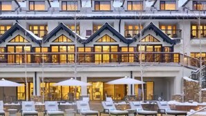 A hotel with a pool area, lounge chairs, and a large building with multiple balconies. - Guest Room - 1 King (Vail)