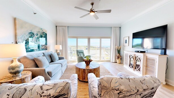 A modern living room with a sofa, armchairs, a coffee table, and a TV. - Beach Manor 0604 (Miramar Beach)