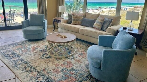 A living room with a view of the beach, a sofa, two armchairs, a coffee table, and a lamp. - Beachside II 4231 (Miramar Beach)