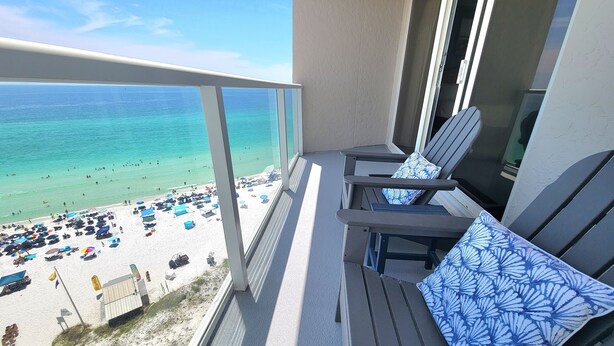 A balcony with a view of a beach, featuring lounge chairs and a railing. - Beachside II 4324 (Miramar Beach)