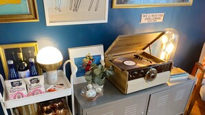 A vintage jukebox, a framed picture, and a sign on a wall.