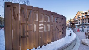 A metal sign with the text "Winter Park" in a public outdoor area with snow on the ground. - Ideal Location with 2 Queens + 2 Twins, Hot Tubs, Pool, & Clubhouse (Winter Park)