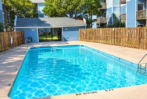 A rectangular swimming pool with a wooden fence surrounding it. - Executive Suite Midtown (Wilmington)
