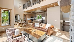 A spacious living area with a high ceiling, a dining area, and a kitchen. - Wow Wow Wow a must stay cabin! (Sevierville)