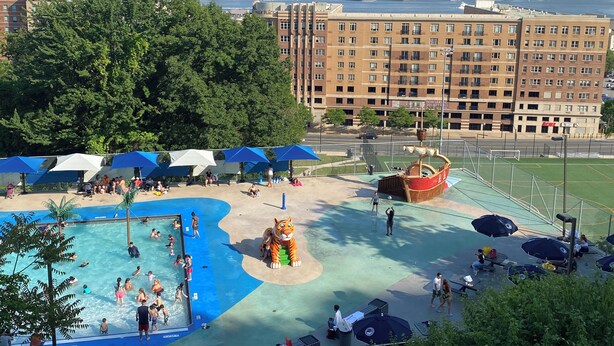 A swimming pool area with a city skyline in the background. - Nice two Bedroom apt at 25 Minutes to New York (North Bergen)