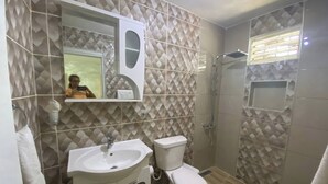 A bathroom with a sink, toilet, and shower. - 6B Santiago Harmonic Apt Especially For You (Santiago de los Caballeros)