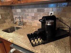 Enjoy cooking and brewing in this well-equipped kitchen with a dishwasher, coffee maker, and sink.