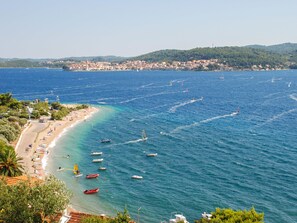 A coastal town with a beach, boats, and a distant city. - Balota - Moreška by Interhome (Orebić/Viganj)