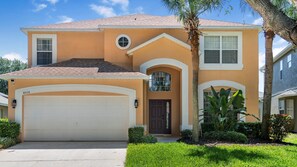 A two-story house with a garage, a front door, and a small porch.
