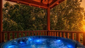 A hot tub in a wooden gazebo with a view of trees. - View To Remember, Stunning Mountain Views, Hot Tub, Game Room, Near Pigeon Forge (Sevierville)