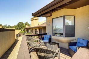An outdoor patio with wicker furniture, a glass table, and a view of the surrounding area. - Sedona Condo on Golf Course w/ Pool Access! (Sedona)