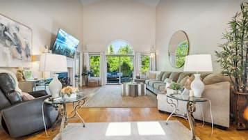 Smart TV, fireplace, books, computer monitors
