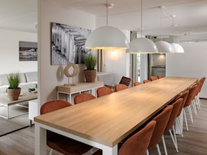 Enjoy meals in this stylish dining area with a long table and comfortable seating for eight.