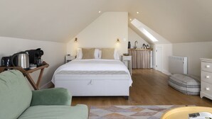 A bedroom with a bed, bedside tables, a coffee maker, a radiator, and a view of the kitchen. - Cosy one bedroom apartment - Keepers Annexe (Cranham)